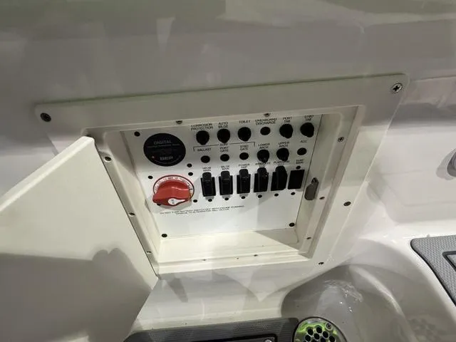 Slide: The Image of Control panel of 2025 Chaparral 2870 SSX boat with switches and dials. - 15