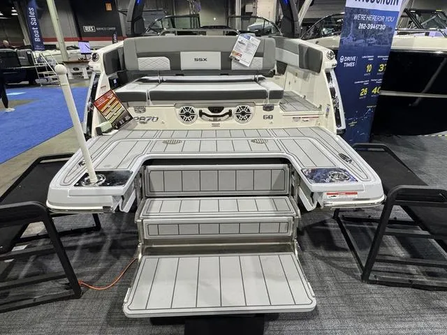Slide: The Image of 2025 Chaparral 2870 SSX boat with spacious deck and seating at a boat show. - 2