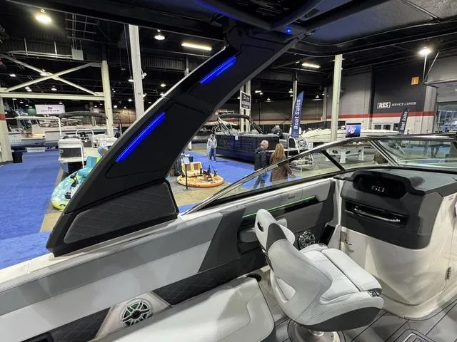 Slide: The Image of 2025 Chaparral 2870 SSX boat interior at a boat show, featuring modern design and seating. - 7