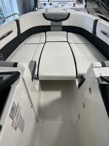 Slide: The Image of 2025 Chaparral 307 SSX boat interior with sleek white seating and modern design. - 12