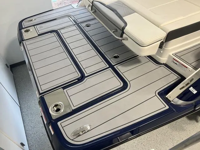 Slide: The Image of 2025 Chaparral 307 SSX boat deck with sleek design and cushioned seating. - 3