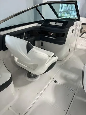 Slide: The Image of 2025 Chaparral 307 SSX boat interior with sleek white seating and modern dashboard. - 8