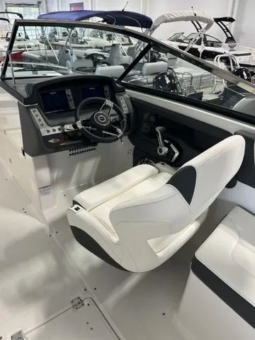 Slide: The Image of 2025 Chaparral 307 SSX boat interior with modern helm and white seating. - 9