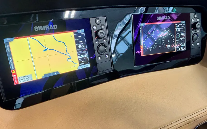 Slide: The Image of 2025 Chaparral 307 SSX dashboard with dual Simrad navigation displays. - 10