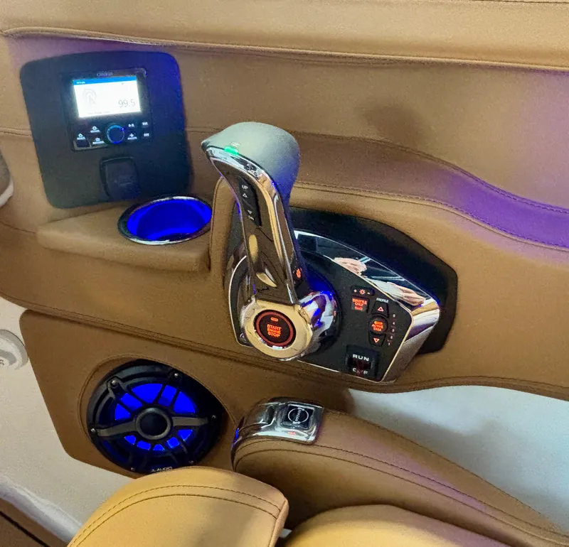Slide: The Image of 2025 Chaparral 307 SSX boat interior with control panel and illuminated cup holder. - 11