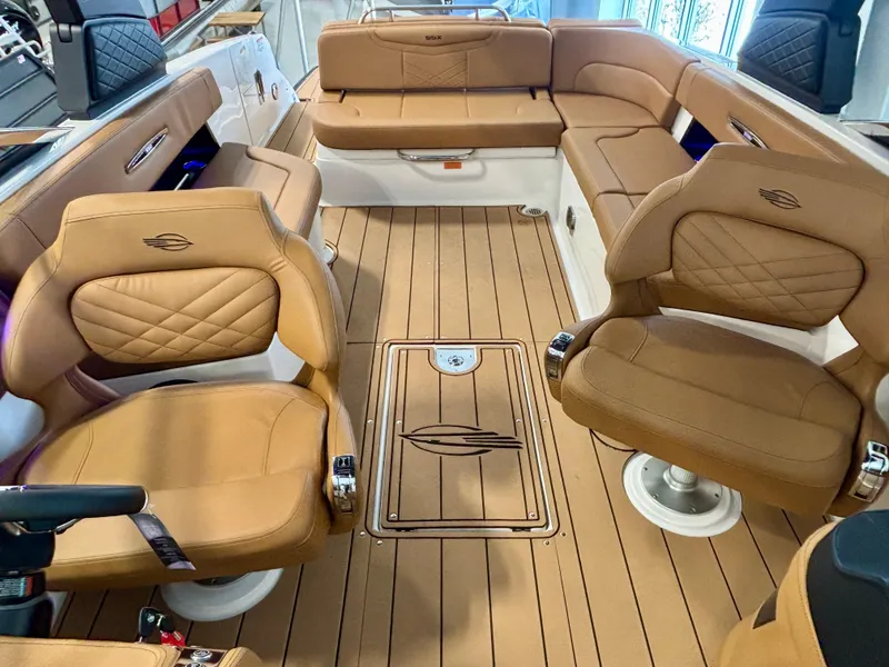 Slide: The Image of Luxurious interior of 2025 Chaparral 307 SSX boat with tan leather seating and wood flooring. - 13