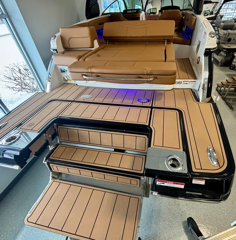 Slide: The Image of 2025 Chaparral 307 SSX boat with luxurious tan seating and sleek deck design. - 16