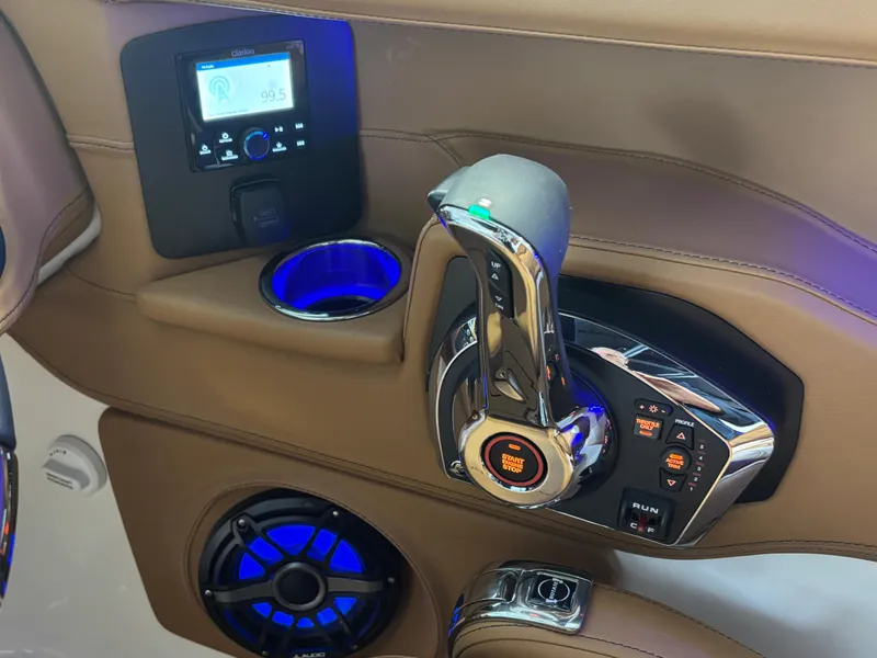 Slide: The Image of 2025 Chaparral 307 SSX boat interior with control panel, throttle, and illuminated speaker. - 5