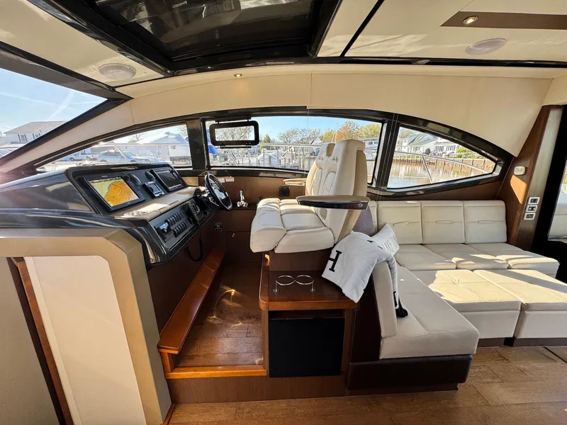 Slide: The Image of Luxurious interior of 2016 Sea Ray 400 Sundancer yacht with helm and seating area. - 15
