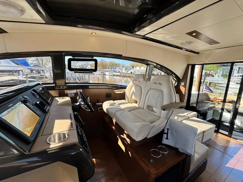 Slide: The Image of Luxurious interior of 2016 Sea Ray 400 Sundancer yacht with modern helm and seating. - 16