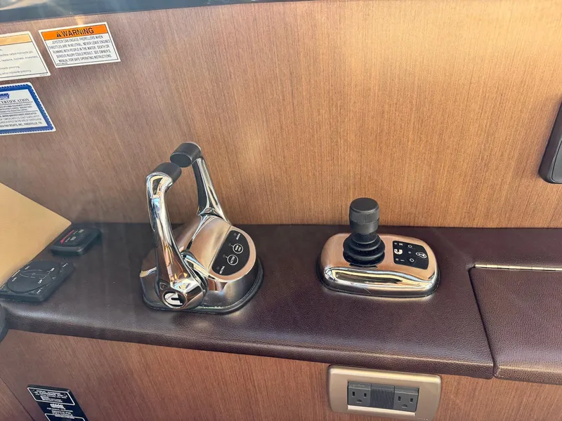 Slide: The Image of Control panel of 2016 Sea Ray 400 Sundancer yacht with throttle and joystick. - 18