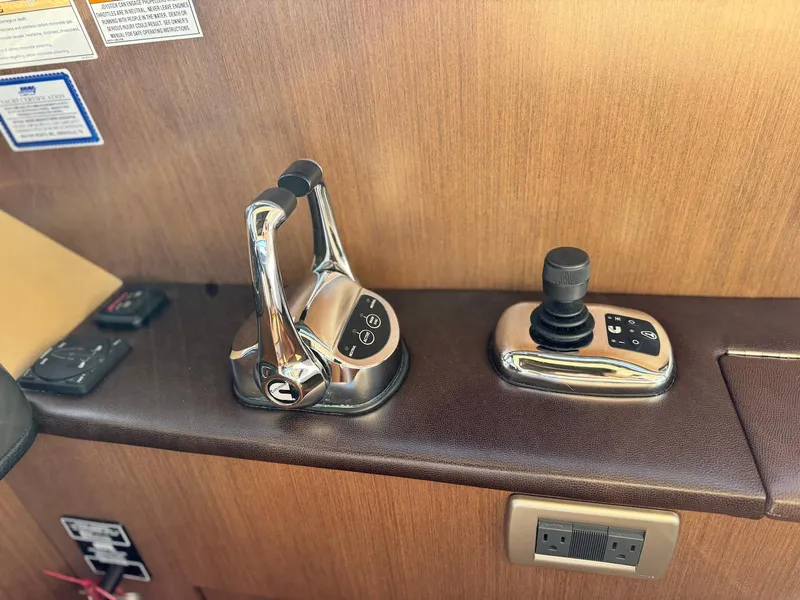 Slide: The Image of Control panel of 2016 Sea Ray 400 Sundancer with throttle and joystick. - 20