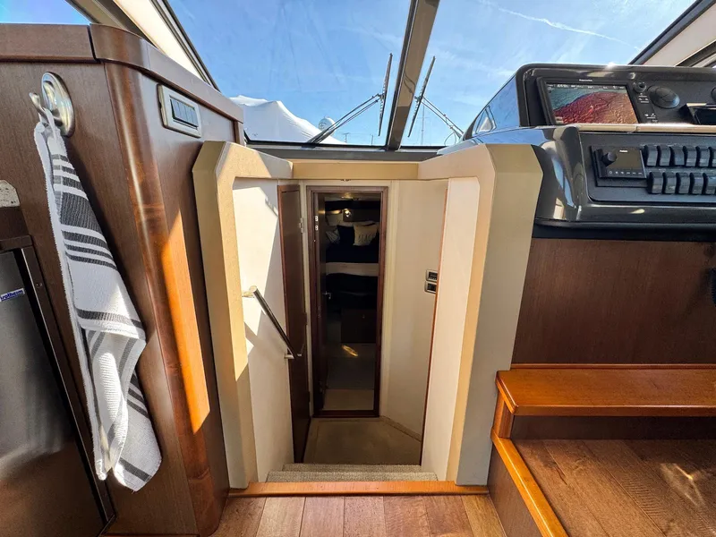 Slide: The Image of Interior view of 2016 Sea Ray 400 Sundancer yacht cabin entrance with wooden finishes. - 23
