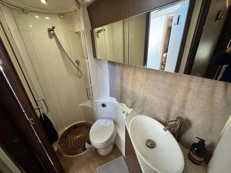 Slide: The Image of 2016 Sea Ray 400 Sundancer bathroom with shower, sink, and toilet. - 31