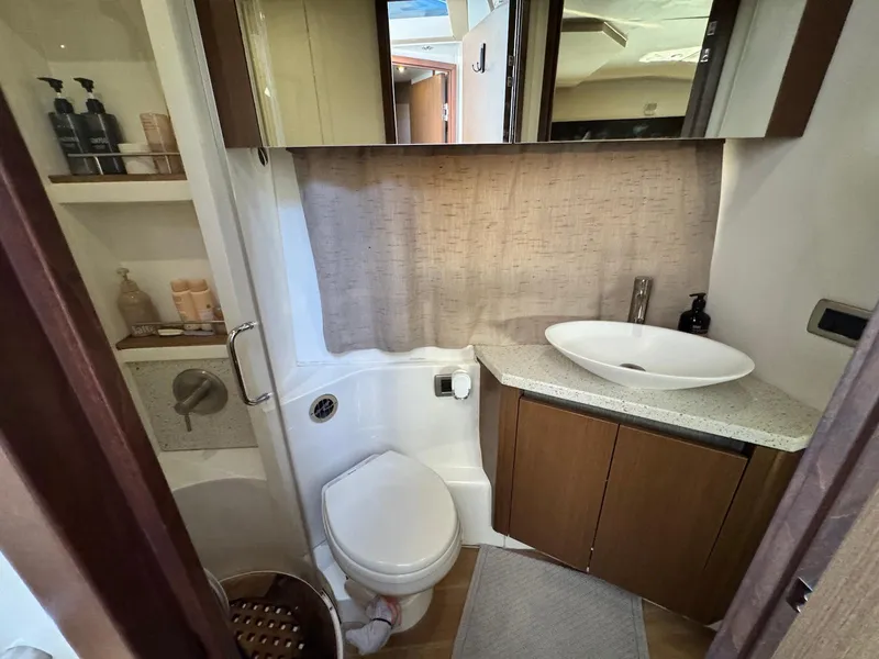 Slide: The Image of Bathroom interior of 2016 Sea Ray 400 Sundancer yacht, featuring modern sink and toilet. - 32