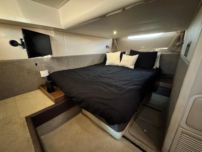 Slide: The Image of Luxurious cabin interior of 2016 Sea Ray 400 Sundancer yacht with cozy bed and TV. - 34