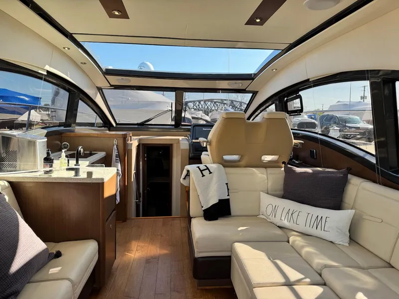 Slide: The Image of Luxurious interior of 2016 Sea Ray 400 Sundancer yacht with plush seating and modern amenities. - 35