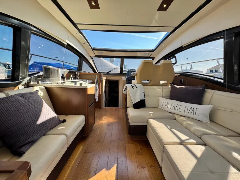 Slide: The Image of Luxurious interior of 2016 Sea Ray 400 Sundancer yacht with plush seating and modern amenities. - 38