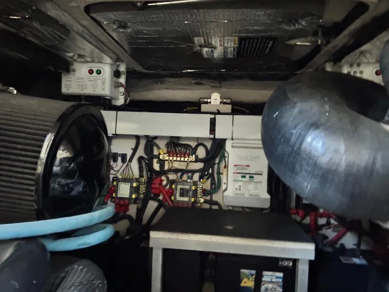 Slide: The Image of Engine room of a 2016 Sea Ray 400 Sundancer with visible wiring and components. - 45