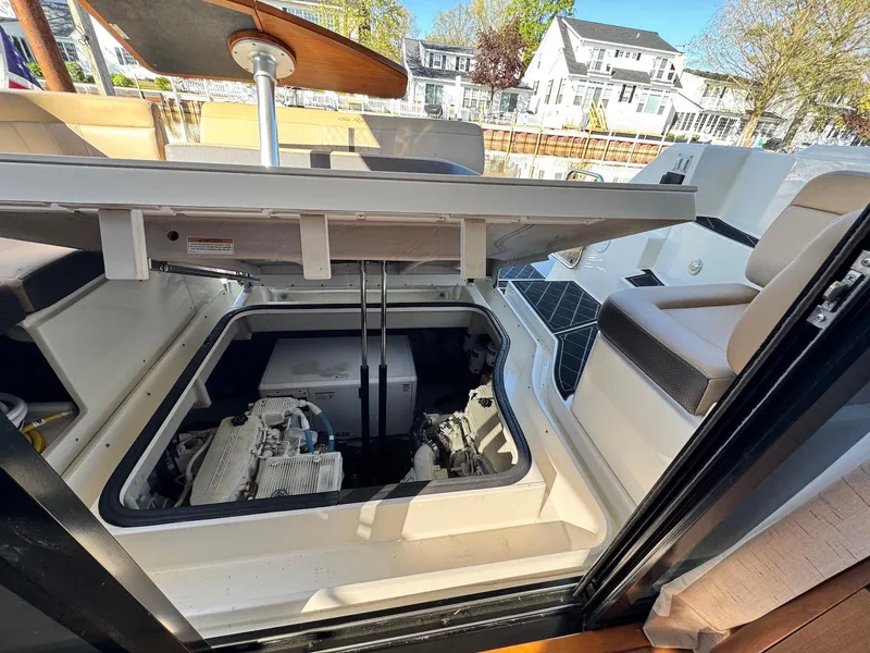 Slide: The Image of Engine compartment of 2016 Sea Ray 400 Sundancer yacht, open hatch, dockside view. - 46