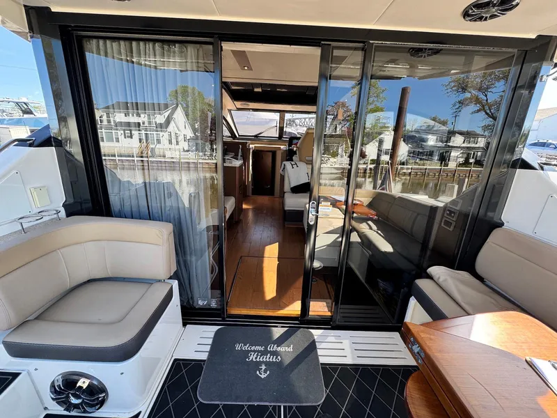 Slide: The Image of 2016 Sea Ray 400 Sundancer yacht interior with seating and glass doors. - 8