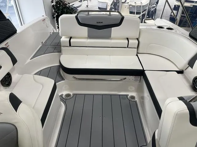 Slide: The Image of 2025 Chaparral 247 SSX boat interior with white seating and gray flooring. - 8