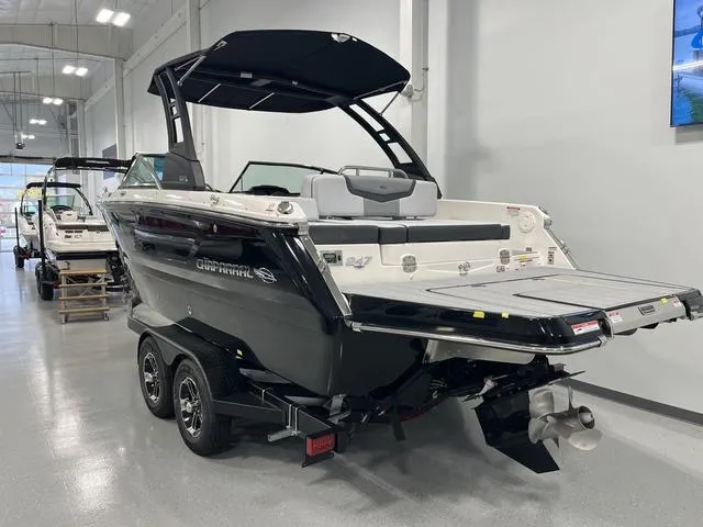 Slide: The Image of 2025 Chaparral 247 SSX boat on trailer in showroom, rear view. - 2