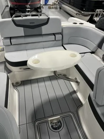 Slide: The Image of 2025 Chaparral 247 SSX boat interior with seating and oval table. - 4