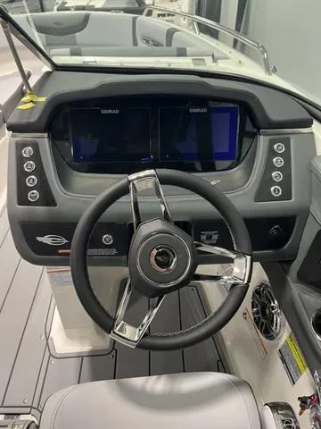 Slide: The Image of 2025 Chaparral 247 SSX boat dashboard with modern steering wheel and dual displays. - 7