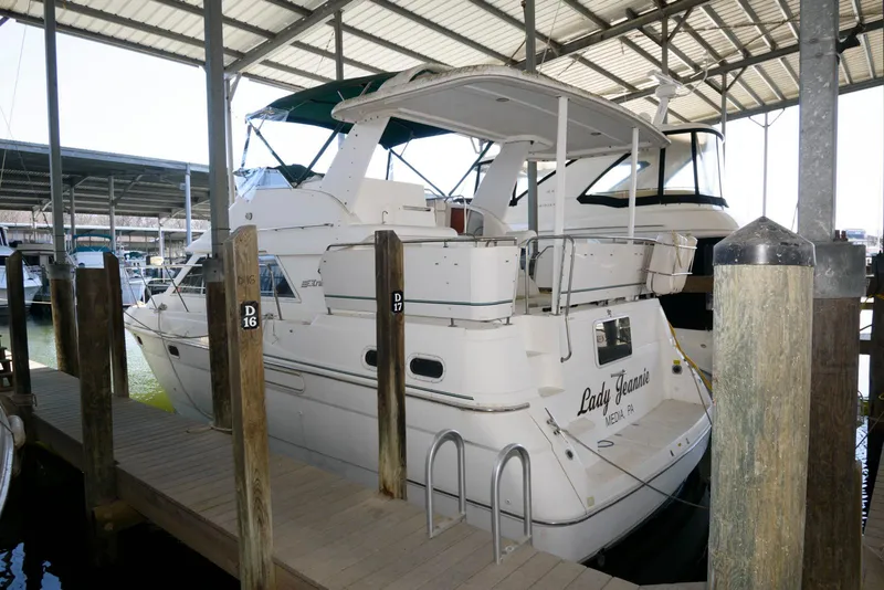 The Image of 1996 Cruisers Yachts 3650 Motoryacht docked in a covered marina. - 0
