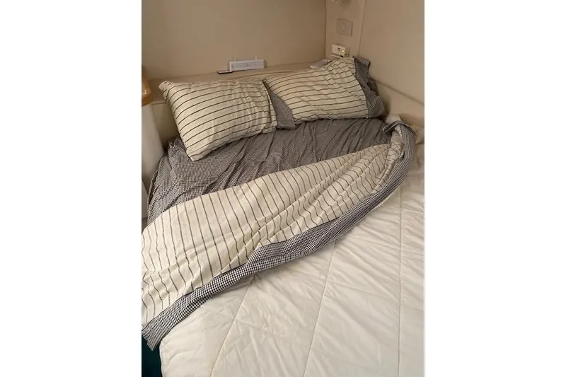 Slide: The Image of Cozy bed with striped bedding inside a 1996 Cruisers Yachts 3650 Motoryacht cabin. - 14