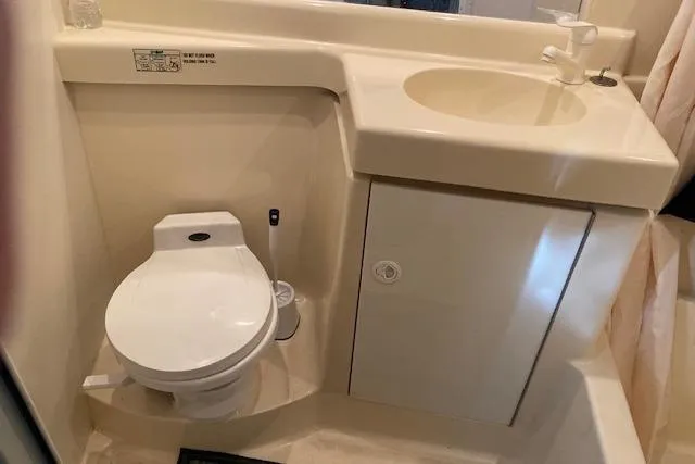 Slide: The Image of 1996 Cruisers Yachts 3650 Motoryacht bathroom with toilet and sink. - 15