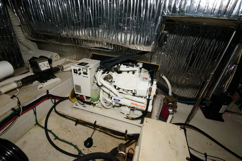 Slide: The Image of Engine room of 1996 Cruisers Yachts 3650 Motoryacht with visible machinery and wiring. - 19