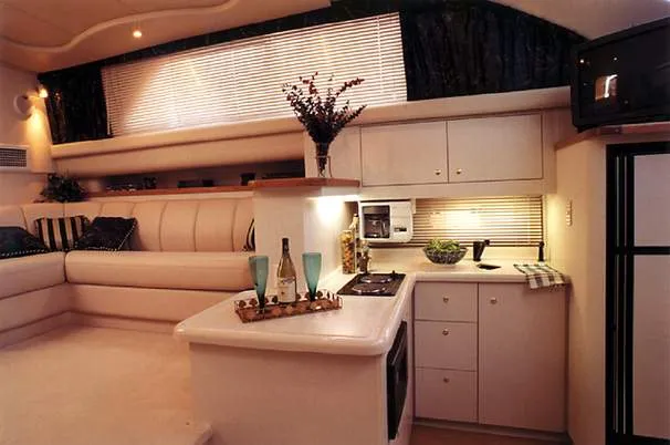 Slide: The Image of 1996 Cruisers Yachts 3650 Motoryacht interior with white seating and green canopy. - 2