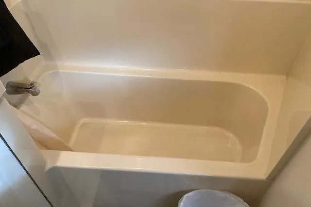 Slide: The Image of Bathtub inside 1996 Cruisers Yachts 3650 Motoryacht, featuring a clean, white design. - 16