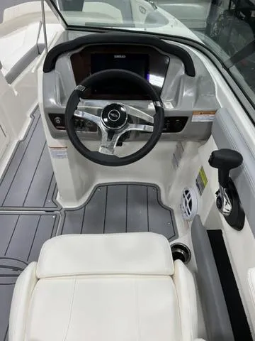 Slide: The Image of 2024 Chaparral 21 SSi boat cockpit with steering wheel and modern dashboard. - 10