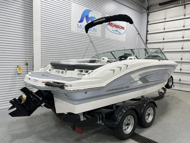 Slide: The Image of 2024 Chaparral 21 SSi boat on trailer in showroom, featuring sleek design and modern features. - 3