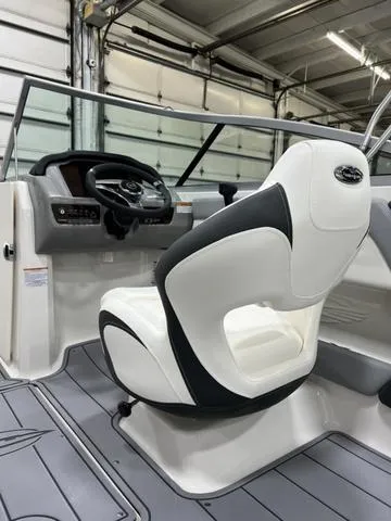 Slide: The Image of 2024 Chaparral 21 SSi boat interior with white captain's seat and steering console. - 9