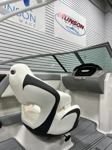 Slide: The Image of 2024 Chaparral 21 SSi boat interior with sleek white and black seating. - 11