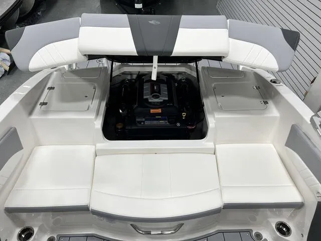 Slide: The Image of 2024 Chaparral 21 SSi boat engine compartment with open seating and storage. - 12