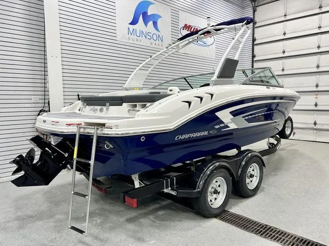 Slide: The Image of 2024 Chaparral 21 SSi boat on trailer in showroom, featuring sleek design and modern features. - 3