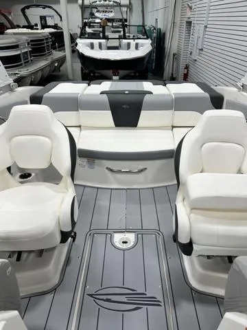 Slide: The Image of 2024 Chaparral 21 SSi boat interior with white seating and gray flooring. - 9
