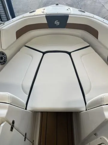 Slide: The Image of 2025 Chaparral 23 Surf boat interior with cushioned seating and sleek design. - 10