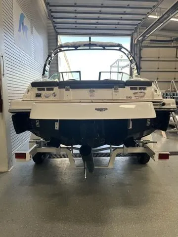 Slide: The Image of 2025 Chaparral 23 Surf boat in a garage, rear view. - 4