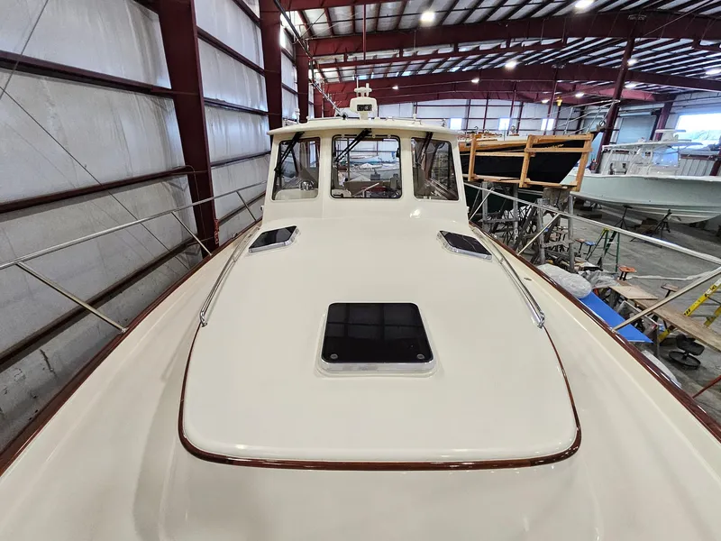 Slide: The Image of 2003 Legacy 40 Hardtop Express boat in a warehouse, viewed from the bow. - 10