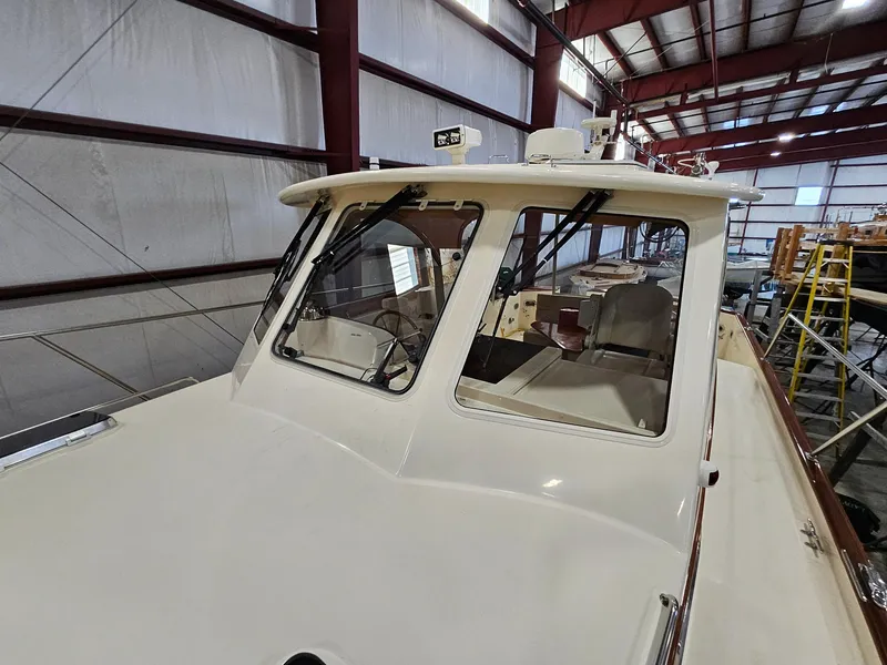 Slide: The Image of 2003 Legacy 40 Hardtop Express boat in indoor storage facility. - 11