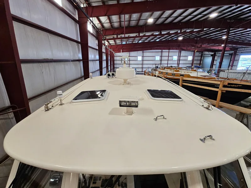 Slide: The Image of 2003 Legacy 40 Hardtop Express boat in indoor storage facility. - 12