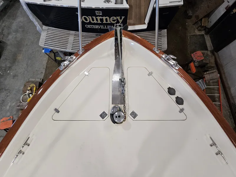 Slide: The Image of Bow of 2003 Legacy 40 Hardtop Express boat with anchor and deck details. - 13