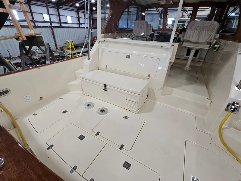 Slide: The Image of 2003 Legacy 40 Hardtop Express boat interior with seating and storage compartments. - 14