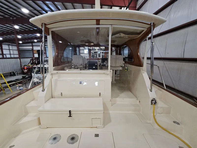 Slide: The Image of 2003 Legacy 40 Hardtop Express boat interior in a warehouse setting. - 16